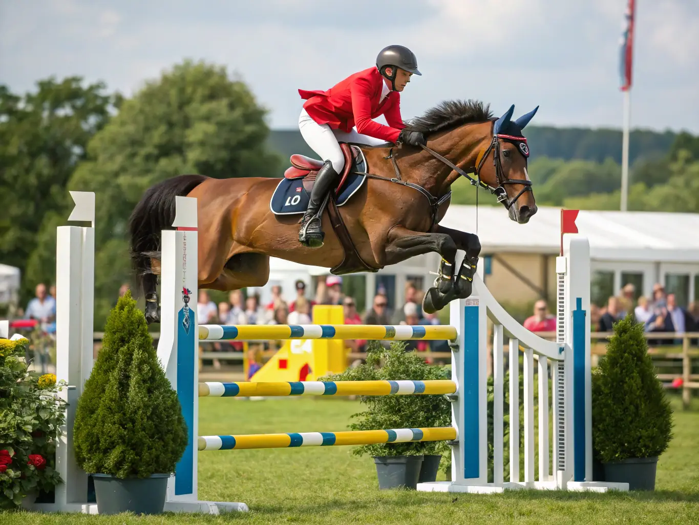 A skilled equestrian rider competing in a show jumping event at CONCOURS HIPPIQUE LA ROCHEFOUCAULD, demonstrating the precision and skill involved.
