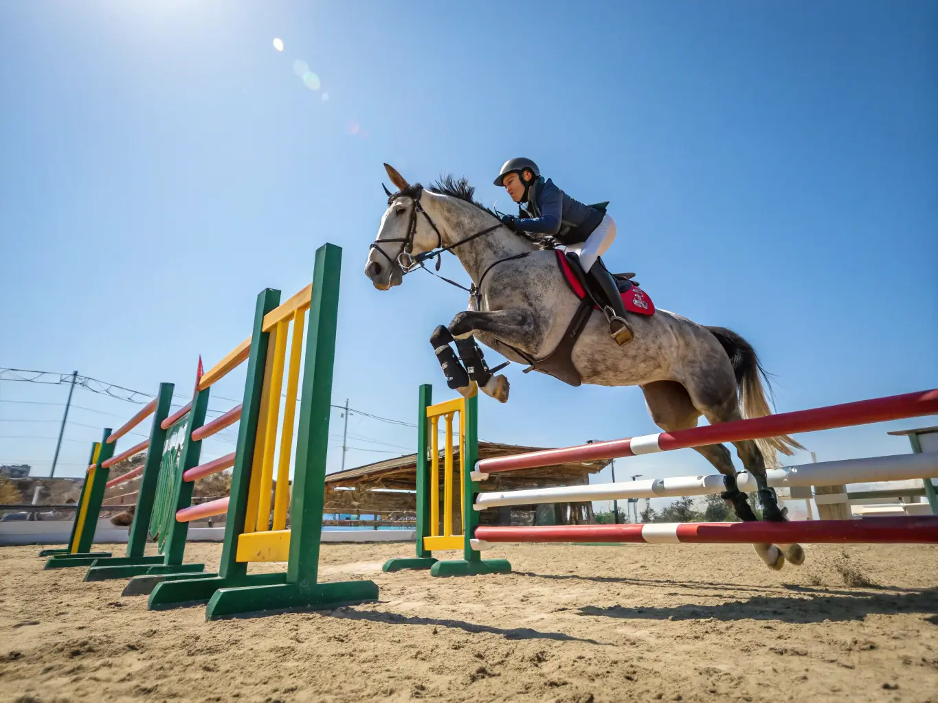 A young rider skillfully guiding their horse over a jump during a show jumping competition at CONCOURS HIPPIQUE LA ROCHEFOUCAULD, showcasing the precision and teamwork involved in the sport.